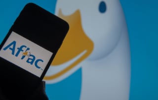 Close-up of a smartphone with aflac logo and duck