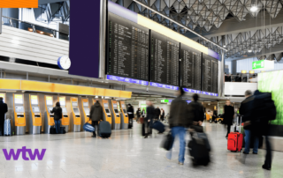 Airport terminal with travelers and check-in kiosks