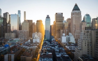 Cityscape featuring high-rise buildings under a golden sky