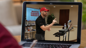 Close-up of a laptop showing a live zoom real estate class.