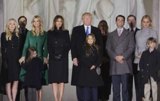 A group of people dressed formally, standing outdoors at a gathering