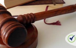 Wooden gavel and legal books representing justice and law, with "cres claimprevent" logo.