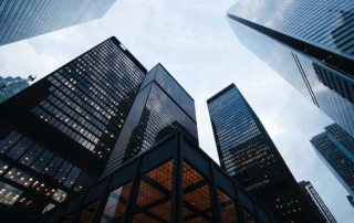 Dramatic view of modern skyscrapers against a cloudy sky