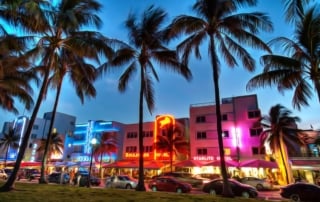 A vibrant evening street scene in miami beach's art deco historic district with neon lights and bustling activity.