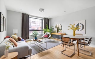 A modern living and dining area showcasing sophisticated and tasteful staging