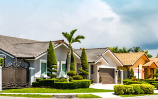 Suburban homes with light exteriors and tile roofs