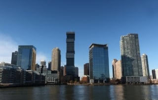 Skyline of a modern city with high-rise buildings along a waterfront