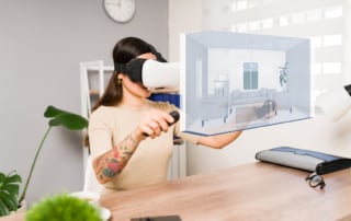 Image of a person using vr headset at desk in virtual environment