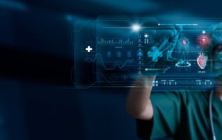 Image of a medical professional in green scrubs using a digital health interface