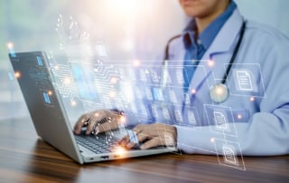 Doctor with laptop and ai graphical overlay indicating modern healthcare environment