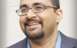 Portrait of professional: blue shirt, dark jacket