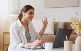 Image of a woman communicating via video call while at home, symbolic of telehealth initiatives in rural mental health care.