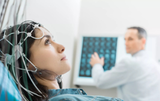 Woman with eeg cap undergoing brain activity monitoring