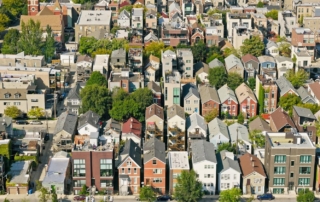 Aerial view of a densely packed urban neighborhood with diverse architectural styles.