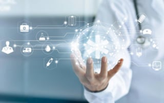 Image of a healthcare professional holding a digital network representation with medical symbols, depicting ai's role in healthcare innovation.