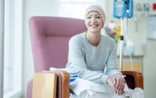 Person in a clinical setting receiving treatment and smiling, conveying hope and positivity