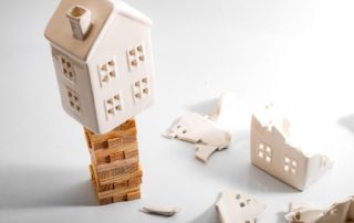 Image of a fragile house model on unstable wooden blocks