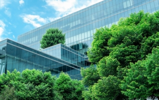 Image of a contemporary glass building entwined with greenery, reflecting urban environmental integration.