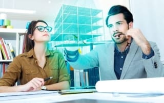 Image of two professionals engaging with virtual real estate technology in a modern office