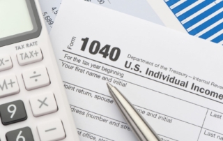 Close-up of u. S. Individual income tax return form 1040 with a calculator and pen