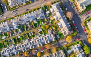 Aerial view of a residential neighborhood showcasing grid-like streets and uniform housing.