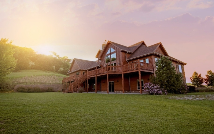 Image of a large two-story wooden house with modern architecture and scenic landscape