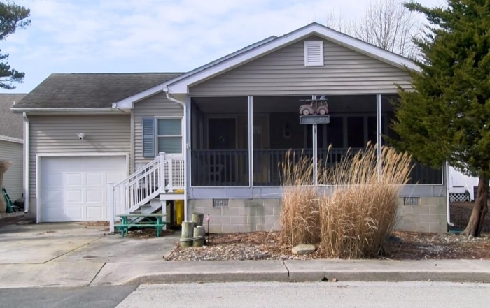 A single-story house with a screened-in porch