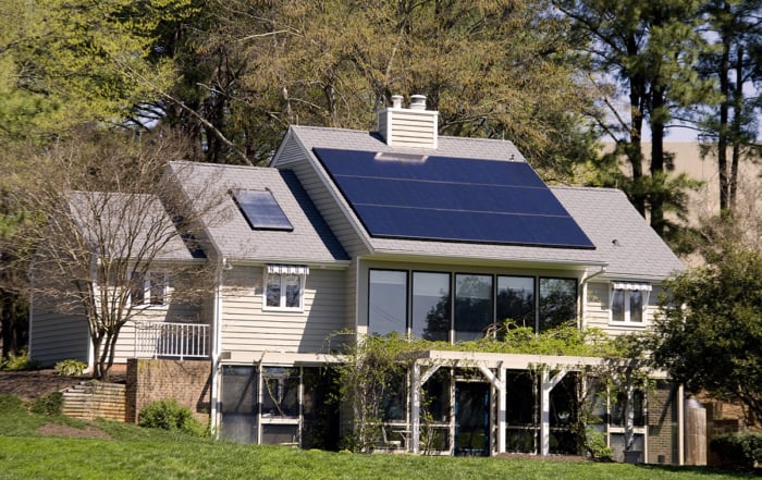 Image of a modern, eco-friendly house with solar panels