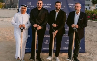 Four men in formal attire holding shovels at a 171 garden heights event