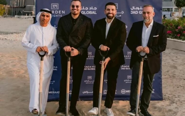 Four men in formal attire holding shovels at a 171 garden heights event