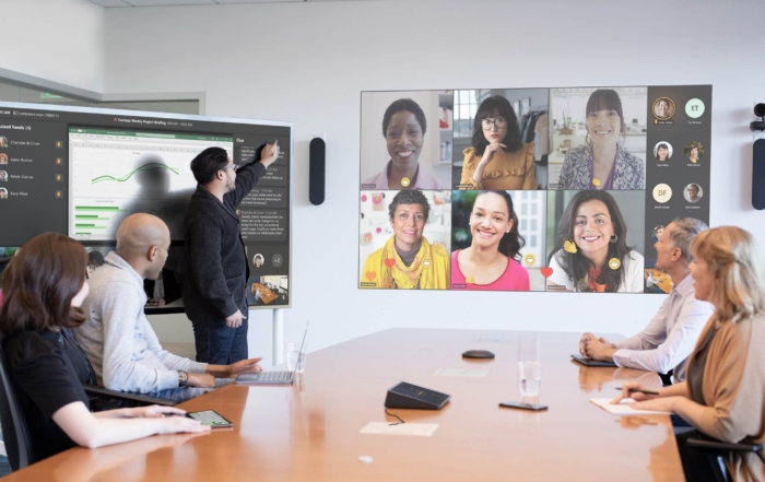 Image of a modern conference room with people in a hybrid meeting, featuring advanced tech for seamless collaboration.