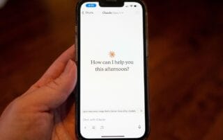 Close-up of a smartphone displaying a chat with ai assistant claude