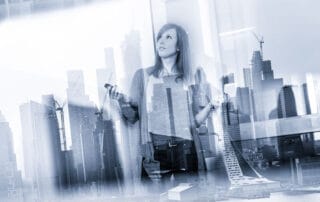 A woman with a smartphone stands before a futuristic cityscape, symbolizing the intersection of technology and real estate.