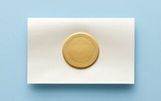 Blank white paper with gold seal on blue backdrop