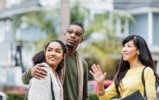 Couple with real estate agent in residential area