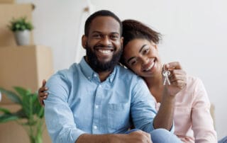 A happy couple in their new home celebrating with house keys
