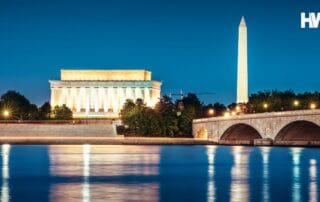 A night scene in washington, d. C. Featuring the lincoln memorial, washington monument, and arlington memorial bridge reflected on the potomac river.