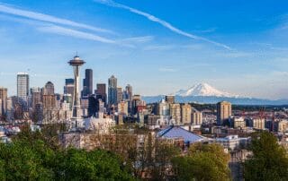 A view of the seattle skyline featuring the space needle and mount rainier.