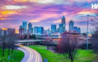 A vibrant cityscape illustrating charlotte, north carolina's skyline at sunset.