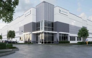 Modern alliance industrial company warehouse and office building exterior with glass entrance and parking lot