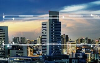 Modern city skyline at dusk with tall office buildings and abstract white tech frame overlay