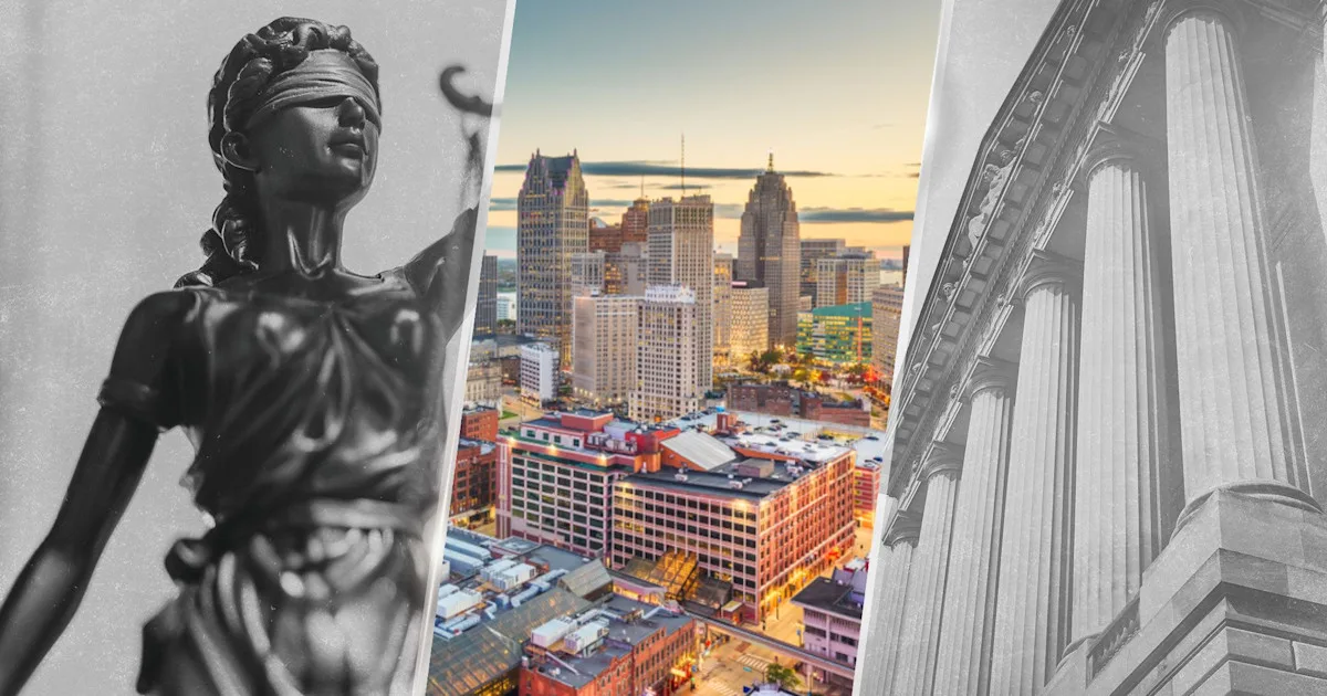 Lady justice over detroit skyline
