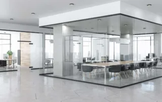 Modern open-plan office with a glass-walled conference room and city view