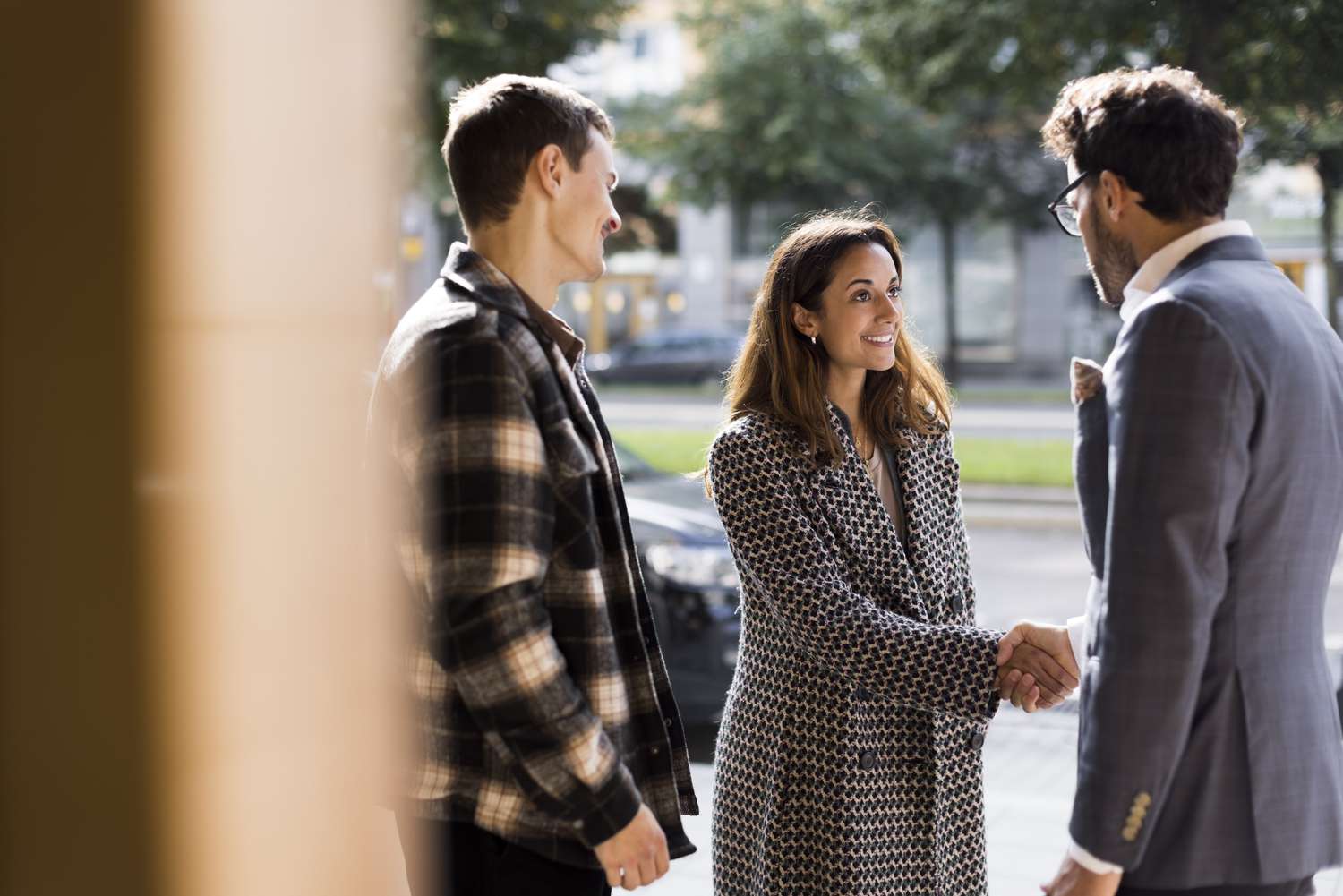Navigating The World Of Online Real Estate Education: Investopedia'S Comprehensive Review 7 Image of three professionals meeting in an urban outdoor setting