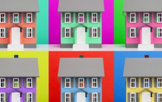 Colorful miniature houses in a grid against bright, contrasting backgrounds