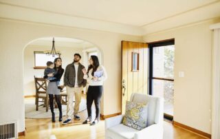Family with real estate agent touring bright living and dining room in a house