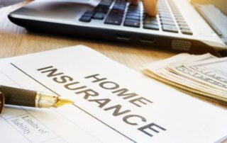 Home insurance document on desk with fountain pen, cash and person using laptop