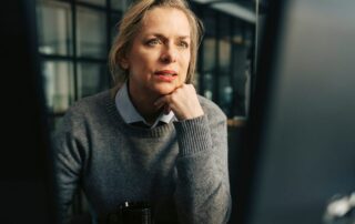 Woman concentrating while working at a computer in a modern office
