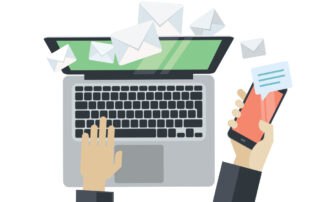 Person using laptop and smartphone to send and receive email messages
