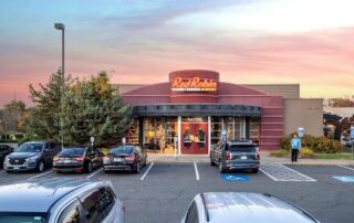 Red robin restaurant exterior with cars parked in front at sunset